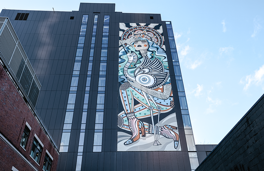 Woman with Blue Heron Banner